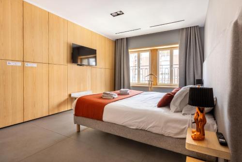 a bedroom with a large bed and a television at Au Chat Qui Dort Lille - Thiers in Lille