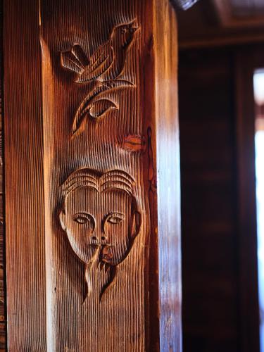 a wooden door with a face on it at Hotel Chesa Grischuna in Klosters