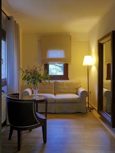 a living room with a couch and a table at Styga Mountain Resort in Zarouchla