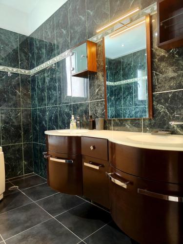 a bathroom with a sink and a mirror at Villa Beata in Perama