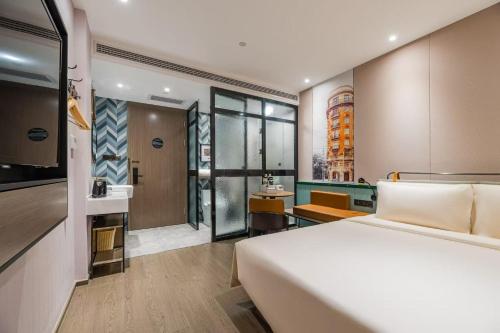 a hotel room with a bed and a bathroom at Atour Light Hotel Shanghai Jing'an Natural History Museum, Suzhou River Bank in Shanghai