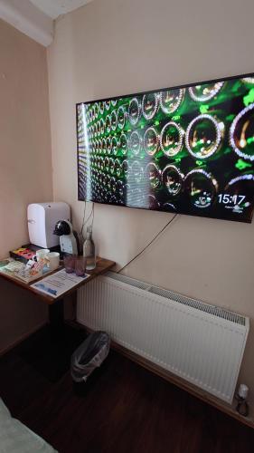 a room with a desk and a painting on the wall at Grand Canal Private Rooms in Dublin