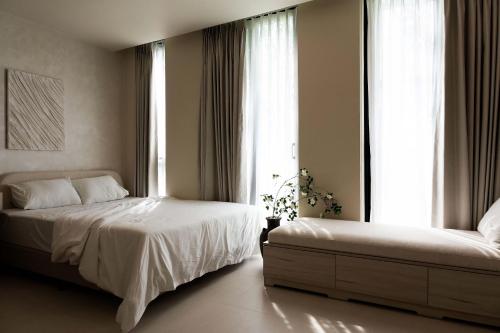 a bedroom with two beds and a large window at EL Where Hotel in Ho Chi Minh City
