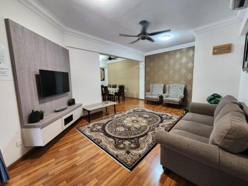 a living room with a couch and a flat screen tv at Andari Homestay Selayang Islam Only in Batu Caves