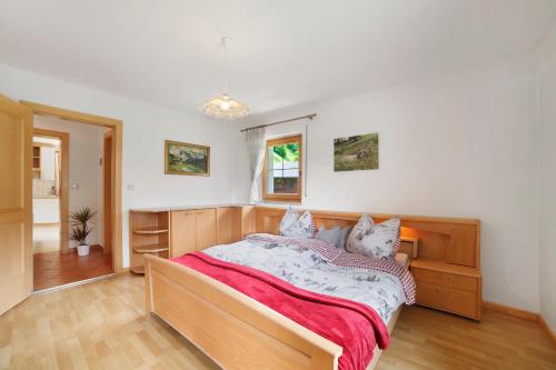 a bedroom with a bed with two cats on it at Hienerhof in Moso
