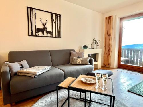 a living room with a couch and a table at Bergchalet mit Pool und Sauna in Missen-Wilhams