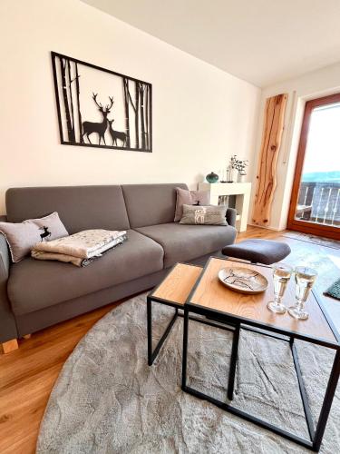 a living room with a couch and a table at Bergchalet mit Pool und Sauna in Missen-Wilhams
