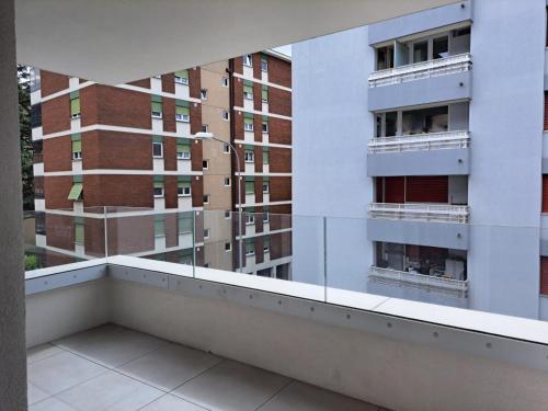 a balcony with a view of some buildings at Urban Residence by Quokka 360 - Apartments with parking in Lugano in Aldesago