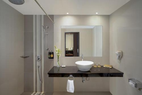 a bathroom with a sink and a shower at Loman Park Hotel Yogyakarta in Yogyakarta