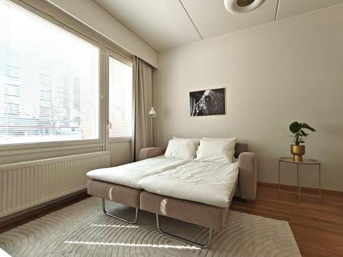a bedroom with a bed and a large window at 46m2 - Location - Parking space - Sauna - Self check-in in Jyväskylä