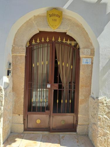 a large wooden door with a sign above it at Anfiteatro Vlll in Canosa di Puglia