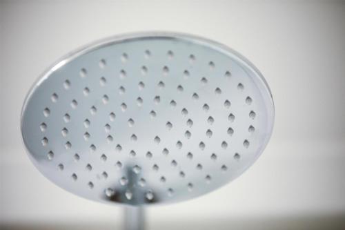 a metal shower head with a drain at Nightcap at the Charles Hotel in Wollongong