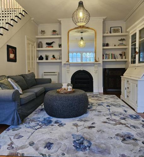 a living room with a couch and a fireplace at Chateau By The Bay in Kingston Beach