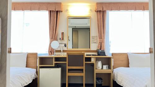 a room with a desk and a bed and a mirror at Toyoko Inn Morioka eki Minami guchi Ekimae in Morioka