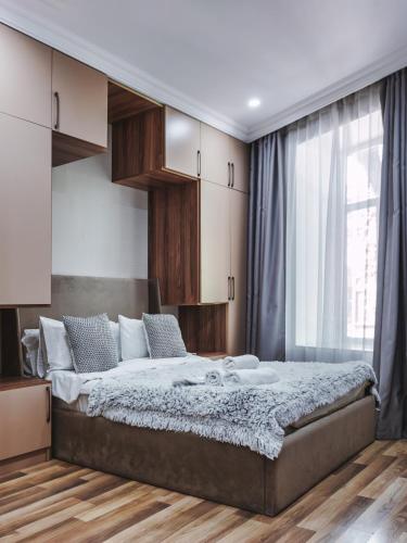 a bedroom with a large bed and a window at Hillside Boutique Hotel Baku in Baku