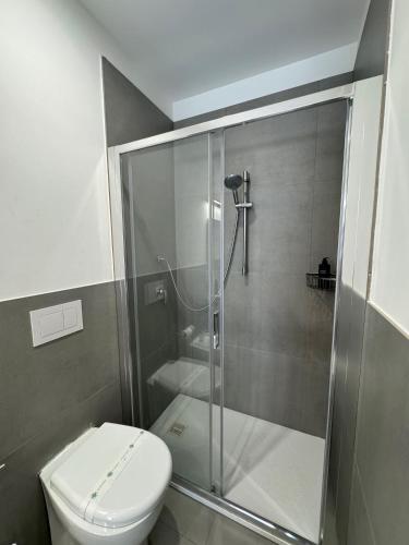 a bathroom with a toilet and a glass shower at Residence Cervia in Cervia