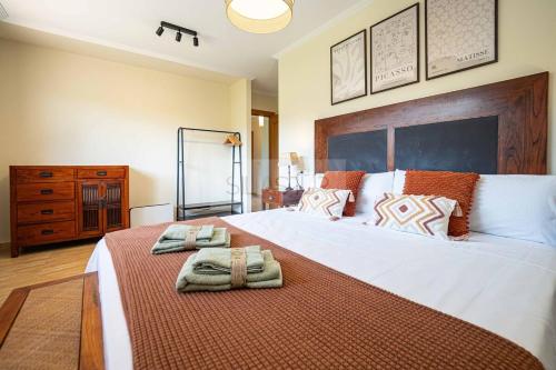 Un dormitorio con una cama grande con dos toallas encima. en Casina de Arroes By Silastur, en Arroes