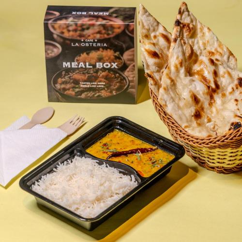 a meal box and a container of rice and a basket of bread at Stay Studio Hotel & Residences in Gurgaon
