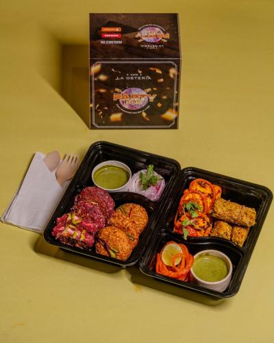 two trays of food sitting on a table at Stay Studio Hotel & Residences in Gurgaon
