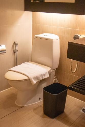a bathroom with a white toilet in a room at The Klagan Hotel in Kota Kinabalu