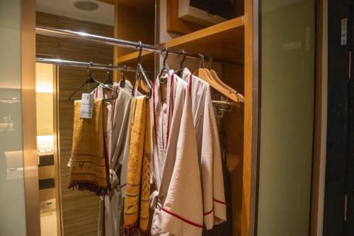 a closet with towels hanging on a rack at The Klagan Hotel in Kota Kinabalu