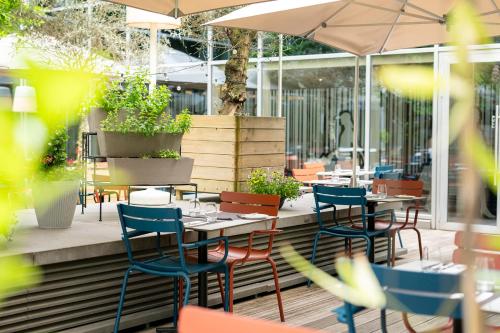 a restaurant with tables and chairs and an umbrella at Thon Hotel EU in Brussels