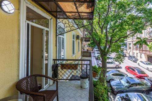 a balcony with a chair and a view of a street at Hillside Boutique Hotel Baku in Baku