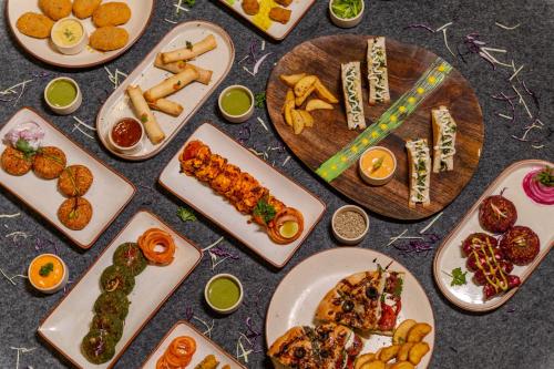a group of plates of food on a table at Stay Studio Hotel & Residences in Gurgaon