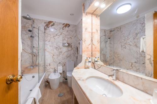 a bathroom with a sink and a shower and a toilet at Pousada de Viana do Castelo in Viana do Castelo