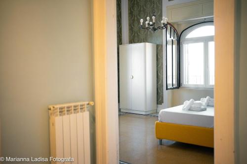 a room with a bed and a refrigerator in it at 8 Archi sul Mare Exclusive Ferris Wheel View in Bari