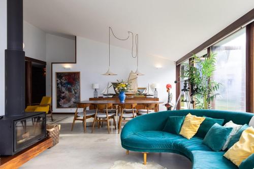 a living room with a blue couch and a fireplace at Casa de Neiva in Esposende