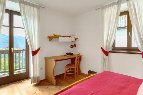 a bedroom with a desk and a bed and a window at Agritur La Gemma in Sant'Orsola Terme