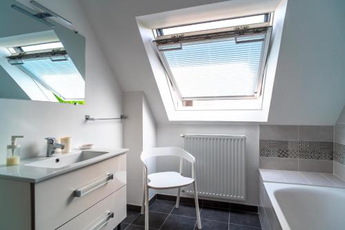 La salle de bains est pourvue d'un lavabo et d'une lucarne. dans l'établissement Parenthèse Iodée - 7min à Pied de la Plage, à Bénodet