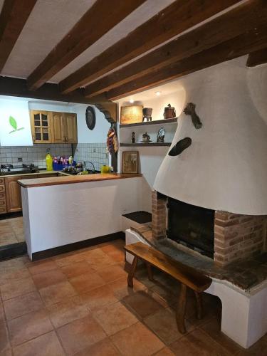 a kitchen with a brick fireplace in a kitchen at Spacious House in Canejan with Mountain View in Caneján
