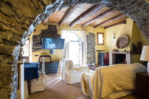 a living room with a stone wall at Su Cuccumeu in Seui