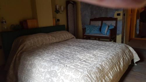 a bedroom with a bed and a chair at Su Cuccumeu in Seui