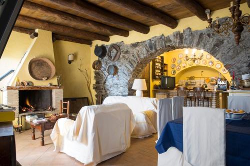 a room with a bed and a stone wall at Su Cuccumeu in Seui