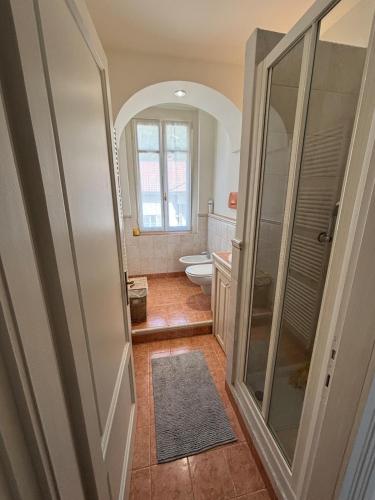 a bathroom with a toilet and a glass shower at IlNanoaComo, HolidayApartment in the Heart of Como in Como
