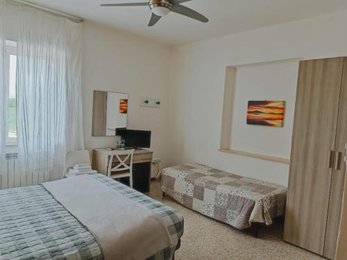 a hotel room with two beds and a ceiling fan at Locanda Zona Franca in San Benedetto del Tronto