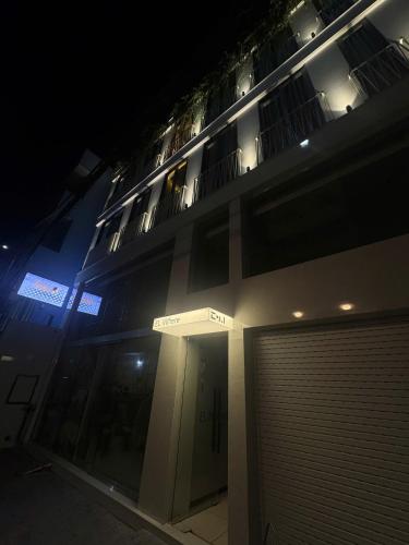 a building with a gate in front of it at night at EL Where Hotel in Ho Chi Minh City