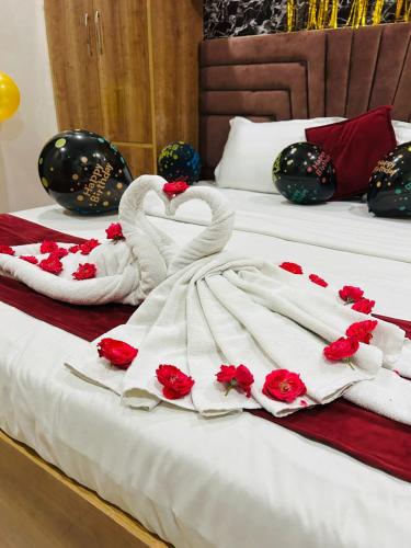 two swans made out of towels on a bed at Rooms for Family - by Hotel RAJ in Haridwār
