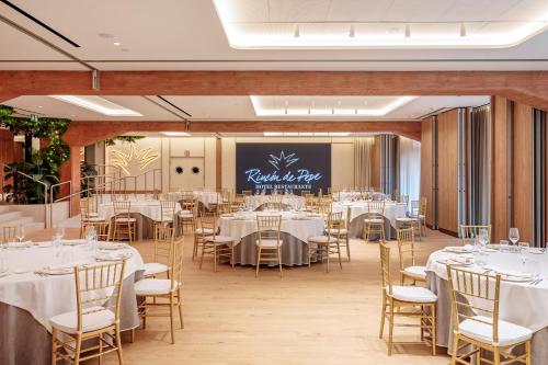 a banquet hall with white tables and chairs at Hotel Murcia Rincón de Pepe Affiliated by Meliá in Murcia