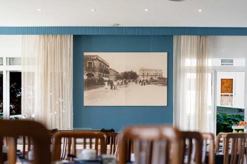 a blue wall with a picture of a street at Hotel Planas in Salou