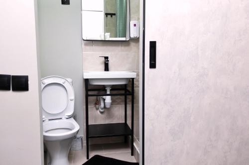 a bathroom with a toilet and a sink at Hotel Tahar in Almaty