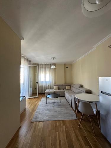 a living room with a couch and a table at Robisa's Haven in Tirane