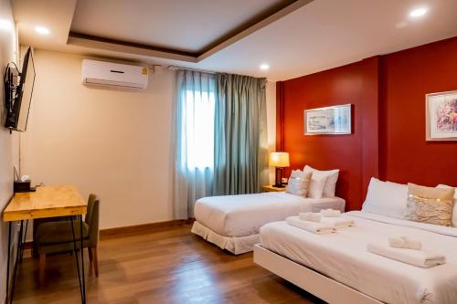 Ένα ή περισσότερα κρεβάτια σε δωμάτιο στο Ployburi Boutique Hotel