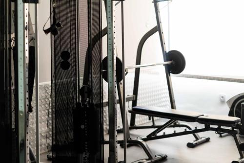 a gym with a chair in front of a rack at Hotel Planas in Salou
