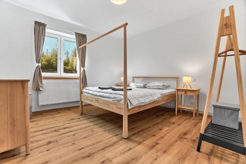 a bedroom with a bed and a ladder in it at Apartmány Jelení vrch in Nové Hamry