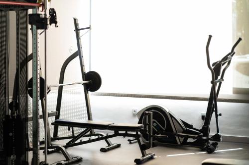 a room with a gym with a chair and weights at Hotel Planas in Salou