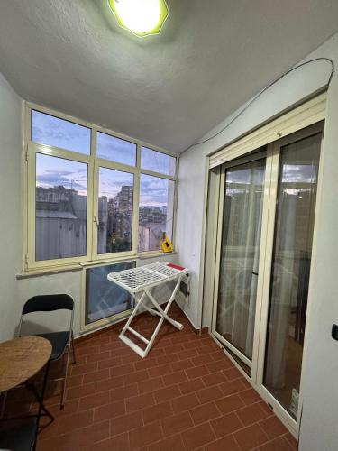 a small room with a table and a window at Robisa's Haven in Tirane